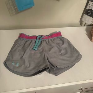 Under armour grey athletic shorts with pink band. Size medium in youth